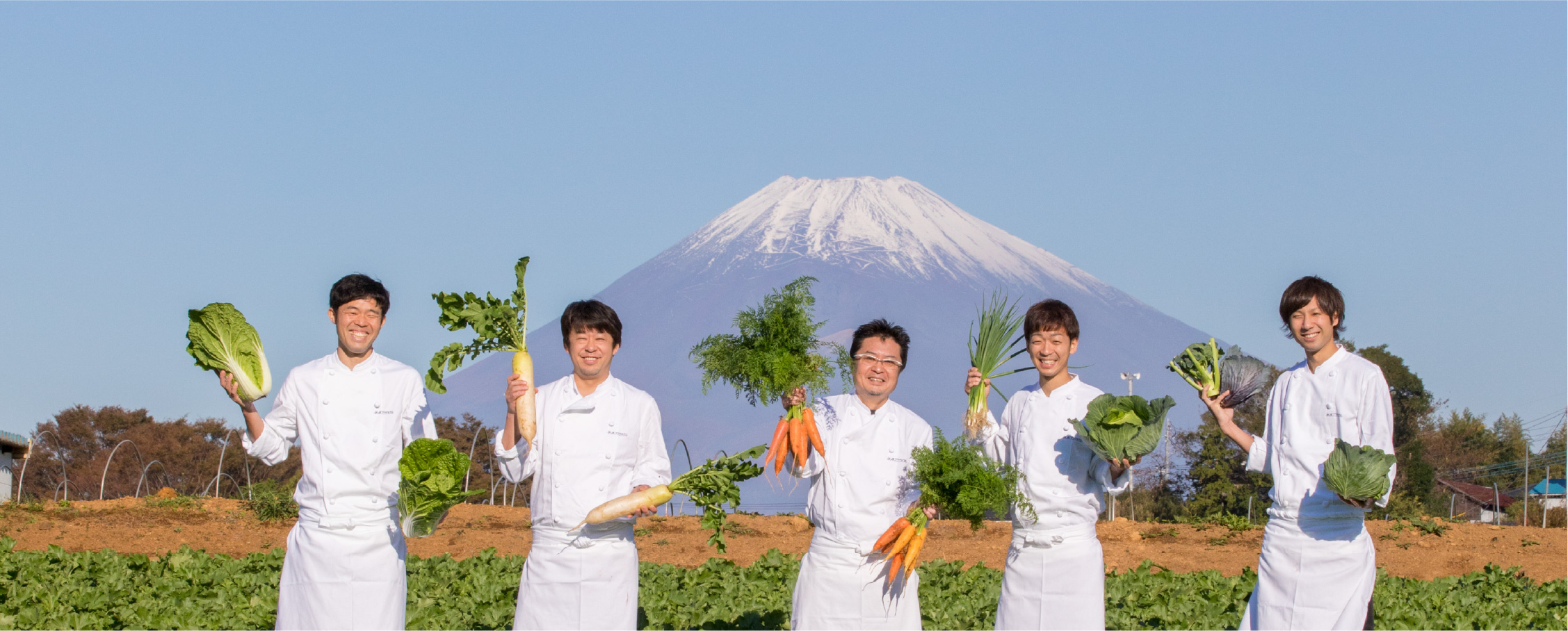 Mishima Plaza Hotel chefs holding Mishima vegetables with Mt. Fuji in the background