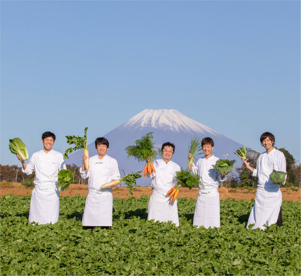 Mishima Plaza Hotel chefs holding Mishima vegetables with Mt. Fuji in the background