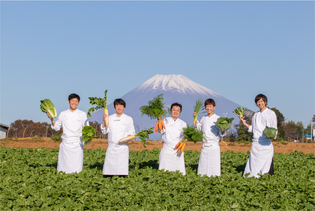 Mishima Plaza Hotel chefs holding Mishima vegetables with Mt. Fuji in the background