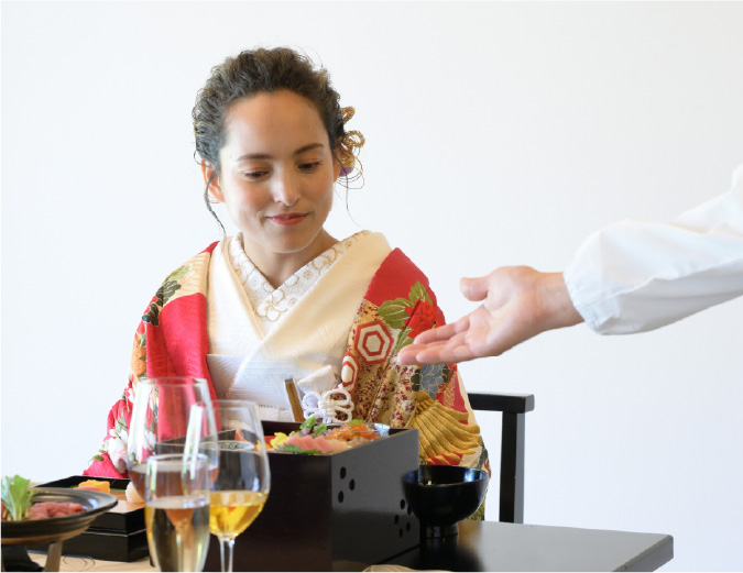 A woman listening to an explanation of Japanese cuisine