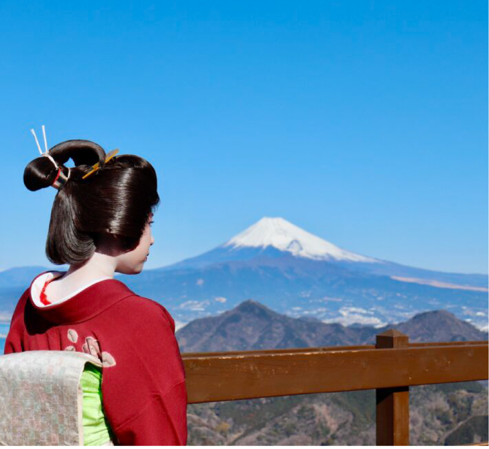 A geisha standing with Mt. Fuji in the background