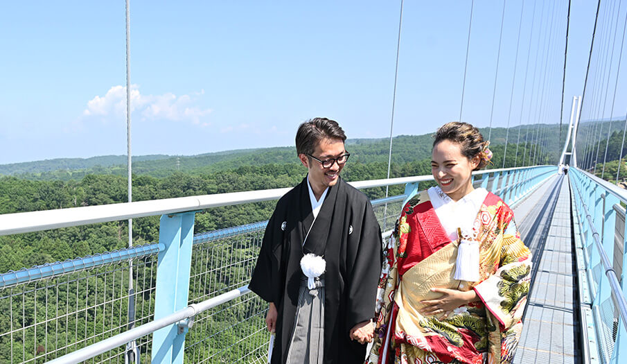 A couple walk the suspension bridge at Mishima Skywalk