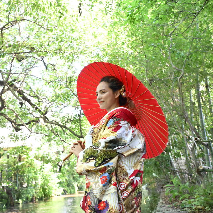 A beautiful woman in kimono standing in green