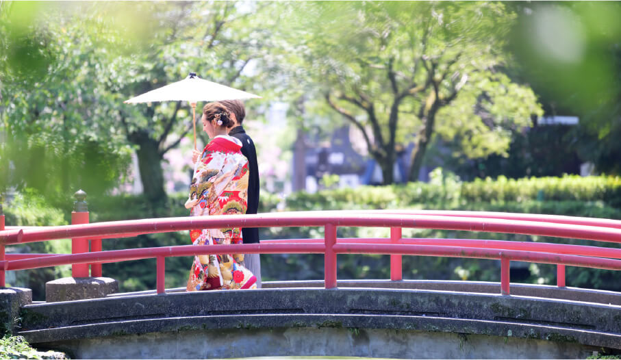 A couple in kimono walking on the bridge in at Mishima Grand Shrine