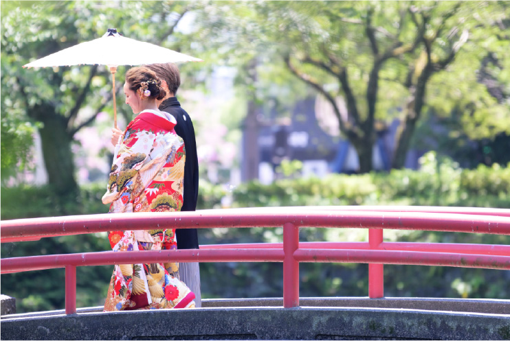 A couple in kimono walking on the bridge in at Mishima Grand Shrine